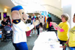 volunteers and mascot interacting at foster care aware 2019